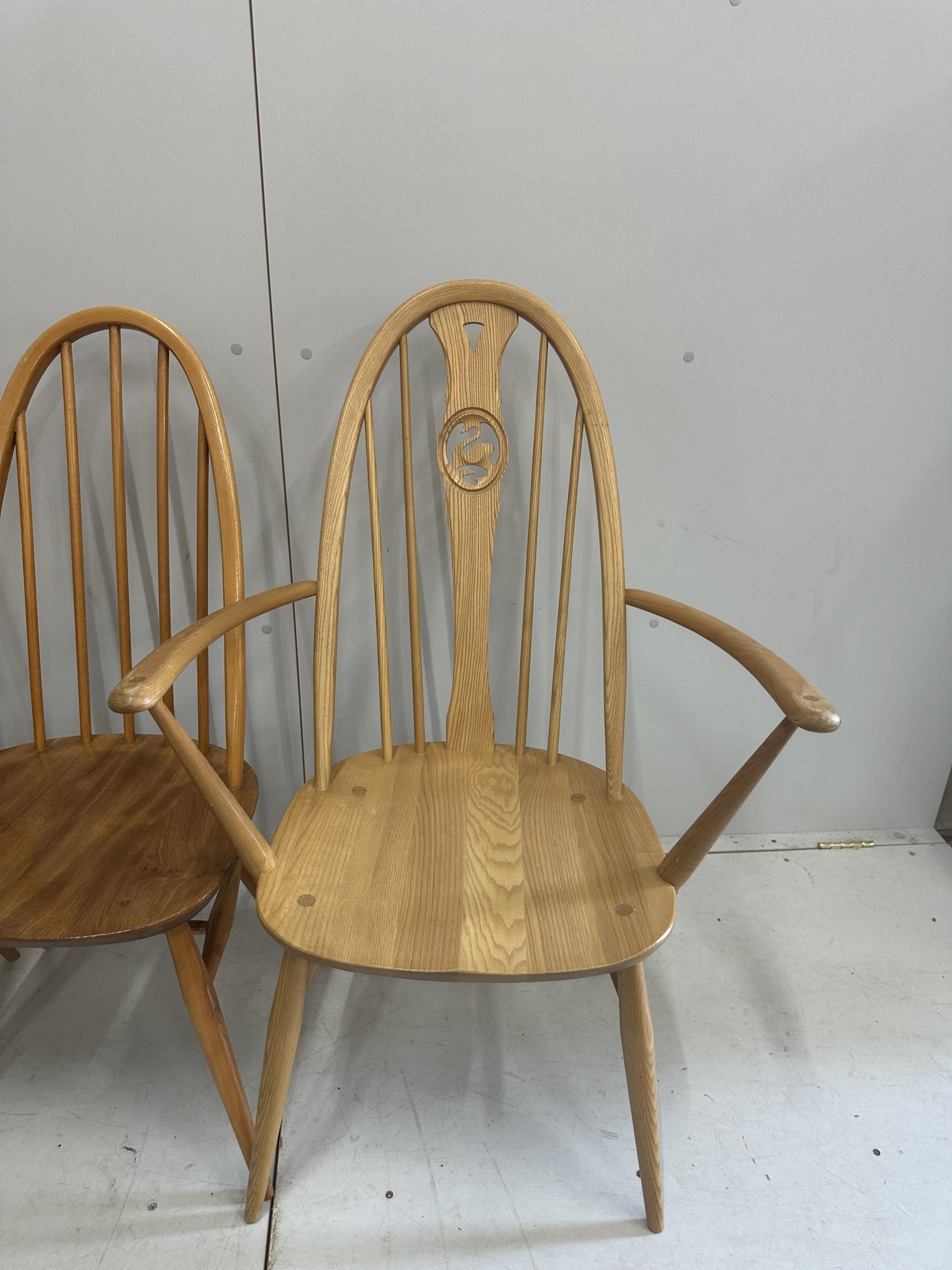 An Ercol elm oval drop leaf dining table, width 124cm extended, height 71cm, together with five Ercol elm, ash and beech dining chairs. Condition - fair to good